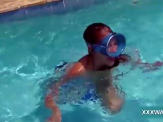 Grand brunette escort Candy swims underwater
